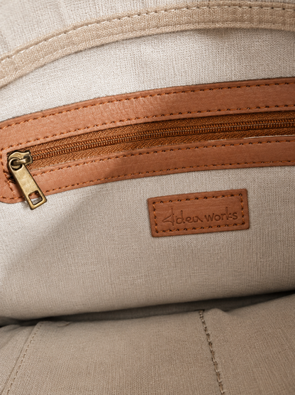 The brand embossed on the bag appears to read “Idea Works”.

Idea Works Tan Leather Crossbody Bag – Pre-Loved Collection