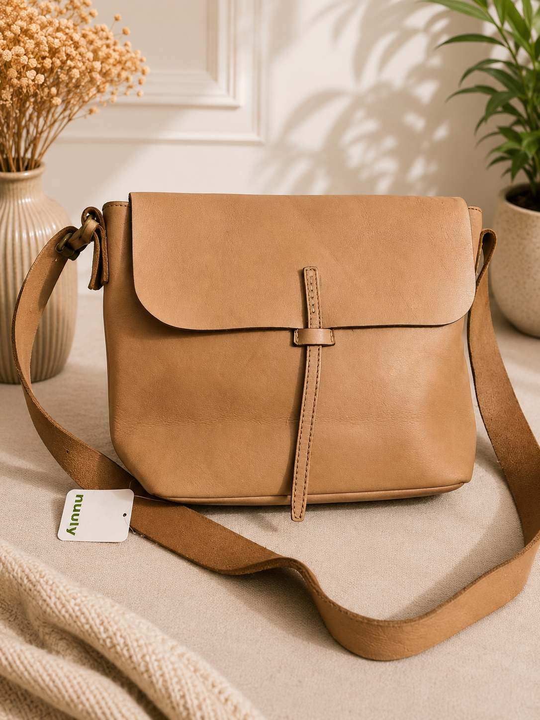 The brand embossed on the bag appears to read “Idea Works”.

Idea Works Tan Leather Crossbody Bag – Pre-Loved Collection